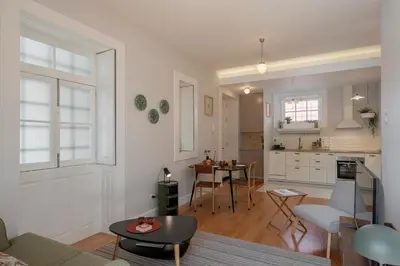 a living room with a couch and a table at OurMadeira - Chill Garden Apartment in Funchal