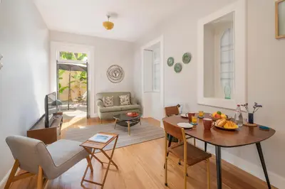 a living room with a table and a dining room at OurMadeira - Chill Garden Apartment in Funchal