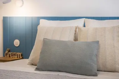 a bed with a bunch of pillows on it at Casa Mateus in Vila do Bispo