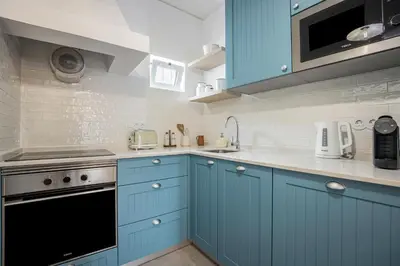 a kitchen with blue cabinets and a sink at Casa Mateus in Vila do Bispo