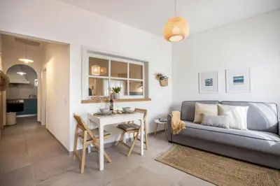 a living room with a couch and a table at Casa Mateus in Vila do Bispo