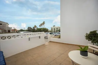 a balcony with a white wall and a table at Casa Mateus in Vila do Bispo