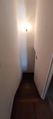 a small hallway with a light on the wall at Downtown Tiny House in Funchal