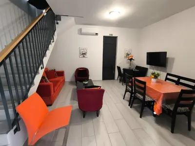a living room with a couch and a table and chairs at Downtown Tiny House in Funchal