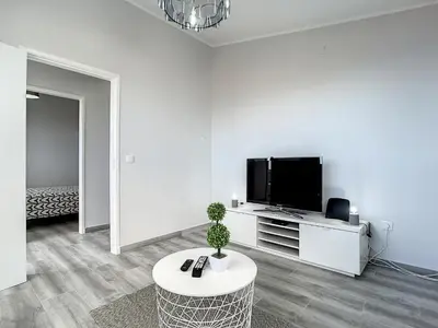 a white living room with a tv and a table at Casa da Avo by Atlantic Holiday in Caniçal