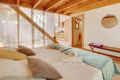 a bedroom with a bed and a bathroom at Calheta Lofts I in Calheta