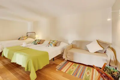 a living room with two beds and a couch at Calheta Lofts I in Calheta