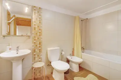 a bathroom with a toilet and a sink and a tub at Calheta Lofts ii in Calheta