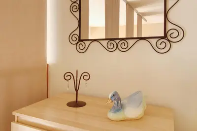 a shelf with a rubber duck on a table with a mirror at Calheta Lofts ii in Calheta