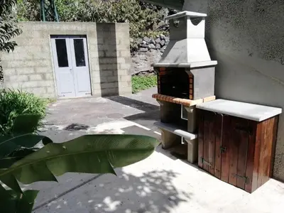 a outdoor stove with a door in a yard at Calheta Lofts ii in Calheta