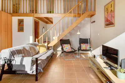 a living room with a couch and a staircase at Calheta Lofts ii in Calheta