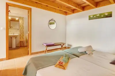 a bedroom with a large bed with pillows on it at Calheta Lofts ii in Calheta