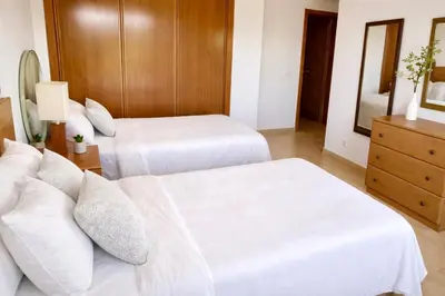 a hotel room with two beds and a couch at Casa Da luz 5 - st james apt 2 bedrooms , Amazing sea view , pool , wifi in Luz