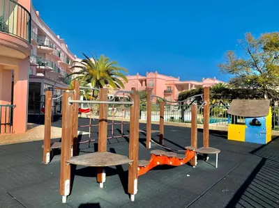 a park with a playground with a swing at Casa Da luz 5 - st james apt 2 bedrooms , Amazing sea view , pool , wifi in Luz