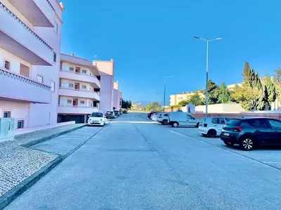 a street with cars parked in a parking lot at Casa Da luz 5 - st james apt 2 bedrooms , Amazing sea view , pool , wifi in Luz