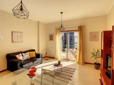 a living room with a couch and a glass table at Theos Apartment by LovelyStay in Funchal