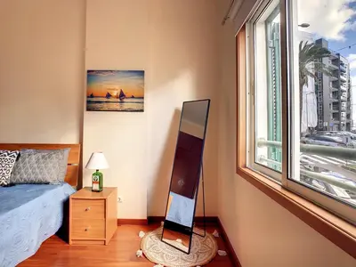 a bedroom with a bed and a large window at Theos Apartment by LovelyStay in Funchal
