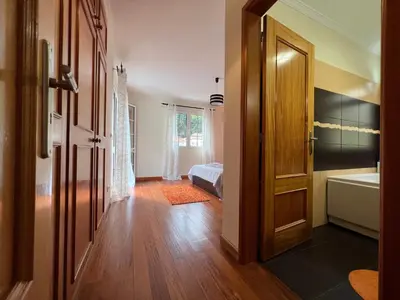 an open door to a bathroom with a tub and a bedroom at Briola by AnaLodges in São Vicente