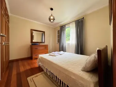 a bedroom with a bed and a dresser and a window at Briola by AnaLodges in São Vicente