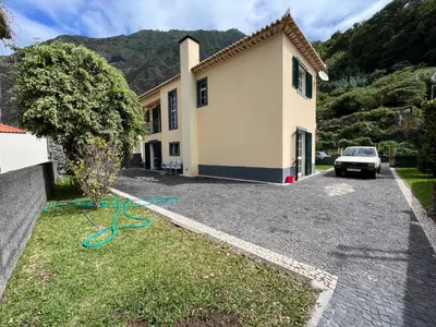 a house with a car parked in the driveway at Briola by AnaLodges in São Vicente