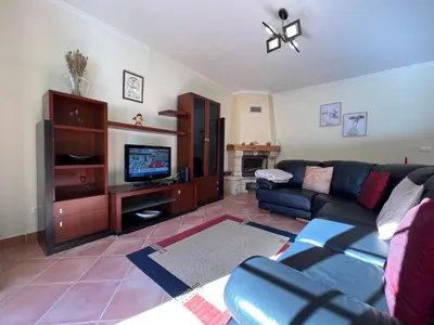 a living room with a couch and a tv at Briola by AnaLodges in São Vicente