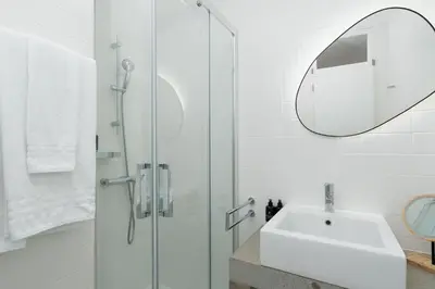 a bedroom with a large bed and a mirror at Unmei by LovelyStay in Caniço
