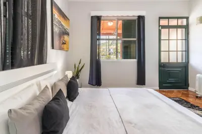 a living room with a white couch and a window at Home Away From Home in Caniçal