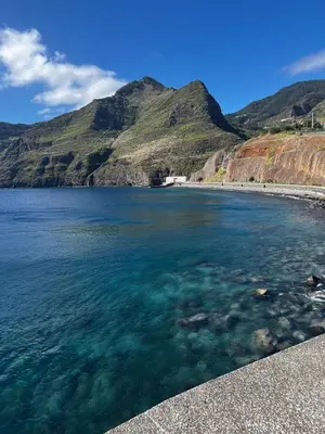 a view of a beach with clear water and mountains at Home Away From Home in Caniçal