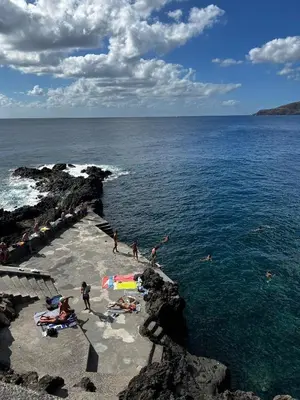 a group of people on a beach near the water at Home Away From Home in Caniçal