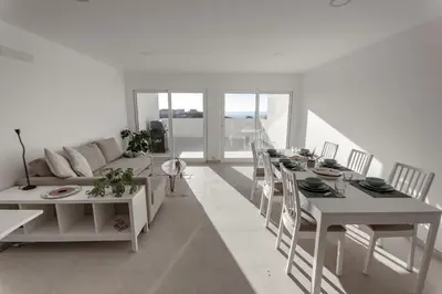 a bedroom with two beds and a balcony at Arrifana Sunset Sea View Villa in Praia da Arrifana