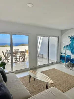 a view of the sunset from the balcony of a condo at Arrifana Sunset Sea View Villa in Praia da Arrifana