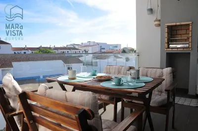 a table and chairs on a balcony with a view at Mar à Vista Burgau in Burgau