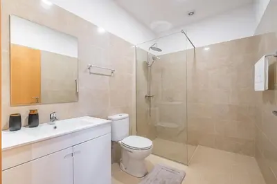 a bathroom with a shower and a toilet and a sink at Canhas Residence I by Homie in Ponta do Sol