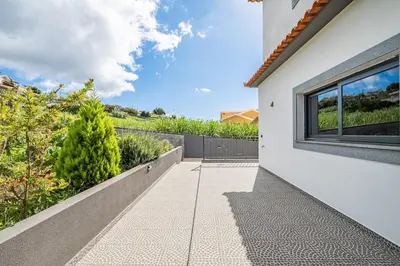 a walkway leading to the side of a house at Canhas Residence I by Homie in Ponta do Sol