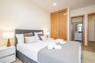 a bedroom with a large bed with towels on it at Canhas Residence I by Homie in Ponta do Sol