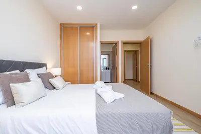 a bedroom with a large white bed with towels on it at Canhas Residence I by Homie in Ponta do Sol