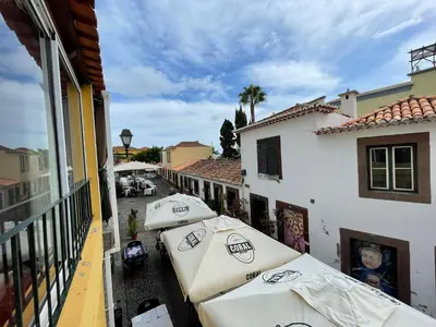 a row of umbrellas sitting next to a building at Fort Traditional Guest House in Funchal