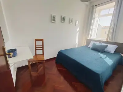 a bedroom with a blue bed and a window at Fort Traditional Guest House in Funchal