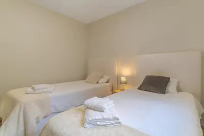 a bedroom with two beds with towels on them at Casa da Hortência do Faial in Faial