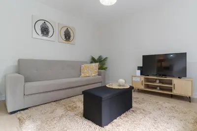 a living room with a couch and a tv at Casa da Hortência do Faial in Faial