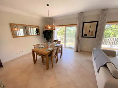 a dining room with a table and a couch at Apartamento Boavista in Lagos