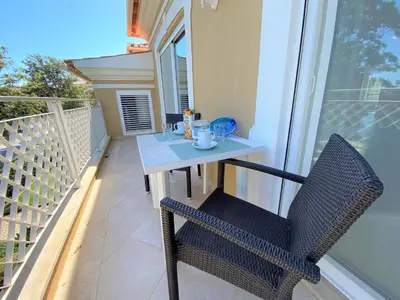 a table and a chair on a balcony at Apartamento Boavista in Lagos