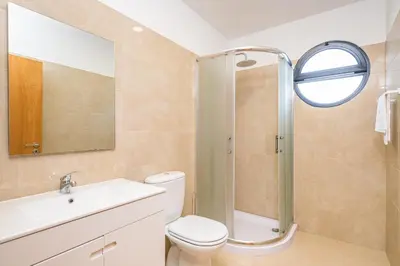 a bathroom with a shower and a toilet and a sink at Canhas Residence II by Homie in Ponta do Sol