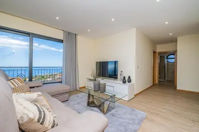 a living room with a couch and a tv at Canhas Residence II by Homie in Ponta do Sol