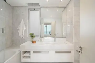 a white bathroom with a large sink and a tub at Madeira Palace III by An Island Apart in Funchal