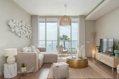 a living room with a couch and a tv at Madeira Palace III by An Island Apart in Funchal