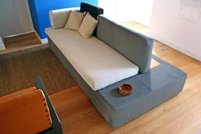 a gray couch sitting in a living room at Casa de Almagreira - Empreendimento de Turismo em Espaço Rural - Casa de Campo in Vila do Porto