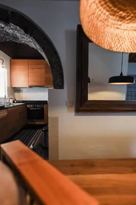 a kitchen with a mirror on the wall at Casa de Almagreira - Empreendimento de Turismo em Espaço Rural - Casa de Campo in Vila do Porto
