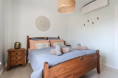 a bedroom with a bed with blue sheets and pillows at Aloha Apartment Arrifana in Praia da Arrifana