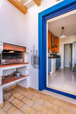 a kitchen with a large blue doorway into a kitchen with a stove at Aloha Apartment Arrifana in Praia da Arrifana